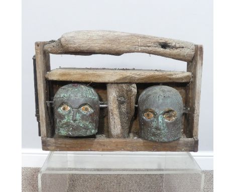 A contemporary driftwood and Verdigris metal Garden Sculpture,&nbsp;formed of two moving male heads, one swivelling the other