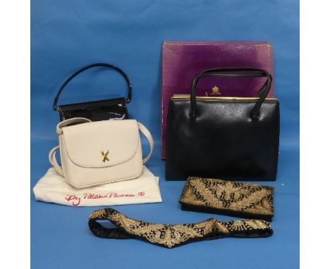 A mid 20thC black leather handbag by Asprey of London, with sliding yellow metal clasp, the dark cream leather interior with 