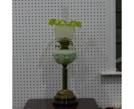 An antique brass and pressed pale green glass Oil Lamp, 71cm high. 
