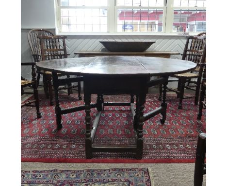 An antique oak gate-leg Dining Table, with turned and block legs, W 137cm x L 150cm x H 72cm.