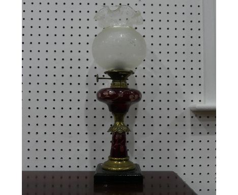 An antique brass and engraved cranberry glass Oil Lamp, 63cm high. 