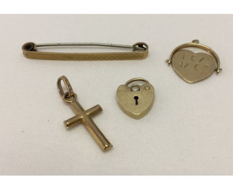 4 small items of gold, comprising: an engine turned bar brooch, heart shaped padlock clasp, a small cross pendant and an 'I l