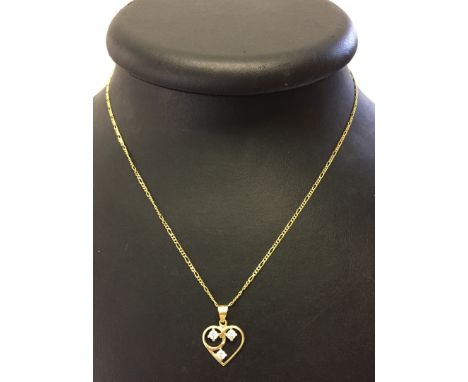 Hallmarked 14ct gold open heart pendant set with 3 cubic zirconias, suspended on a 14ct gold fancy link chain.  Total weight 