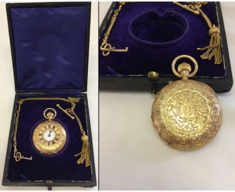 An 18ct gold ladies half hunter pocket watch. With engraved decoration to front and back, enamelled face and blued steel doub