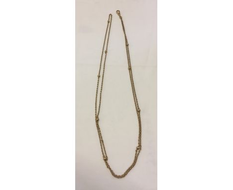 Antique 54" 9ct gold chain, decorated at 6" intervals with gold balls and with a push clasp half way. Weight approx 20.7g.