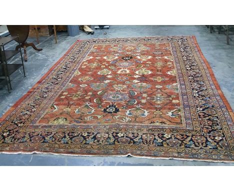 Eastern red ground rug with allover foliate decoration, on a stepped border, 353cm x 263cmCondition ReportThe carpet is worn 