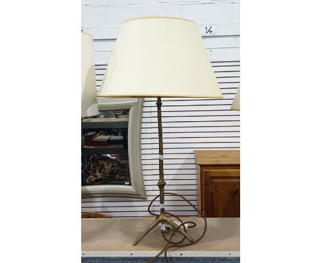 Brass table lamp with turned column and tripod base, with cream shade