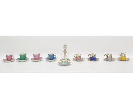 Four Hutschenreuther porcelain coffee cans and saucers with rose, swag and gilt decoration, in various colours, another sauce