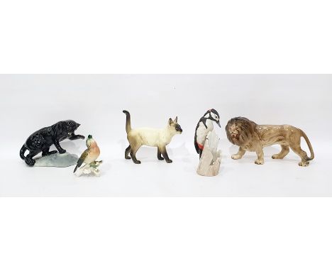 Beswick model black panther on rock, 14cm high, a Melbaware model lion, a Karl Ens porcelain model bird, a Goebel tinted bisq