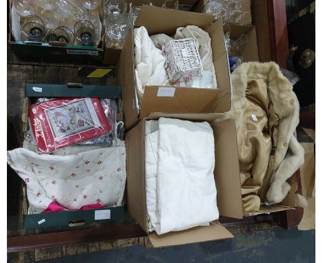 Assorted unused table linen, various cross-stitch patterns by Dimensons and Anchor, bed quilts, shams, a faux-fur coat, knitt