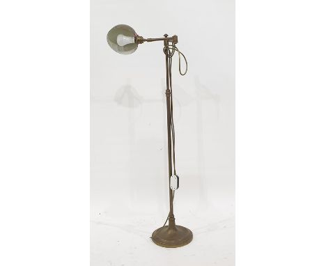 Brass spot lamp on floor-standing telescopic frame 