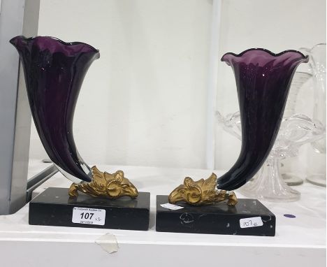 Pair Victorian amethyst glass cornucopia vases, each mounted in ormolu ram’s mask and on variegated black marble plinth base,