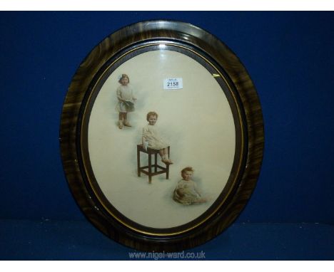 An oval framed Lithograph of Three Studies of Children signed T. Humphrey.