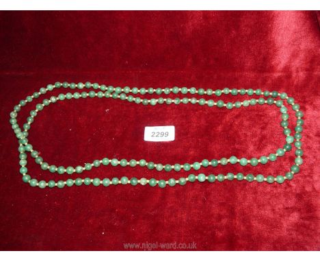 A long strand of Jade beads, 33 1/2'' long.