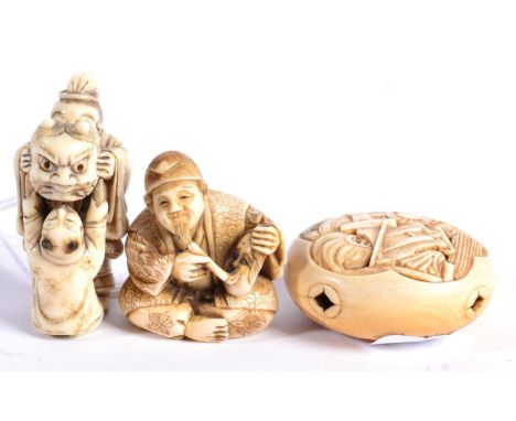 A Japanese Ivory Netsuke, Meiji period, as a seated man painted a Noh mask, 4cm; A Similar Netsuke, as a man and boy playing 