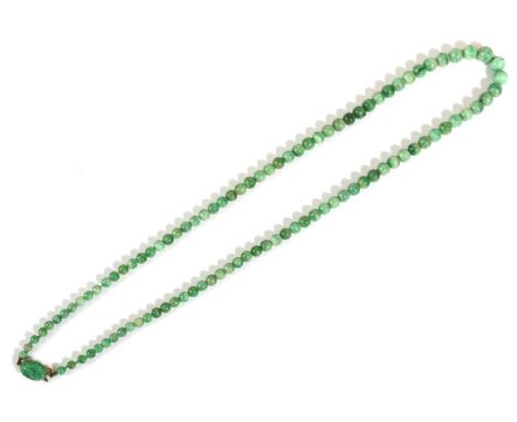 A Jade Bead Necklace, graduated jade beads knotted to clasp with a carved oval jade plaque, length 68cmThe necklace is in goo