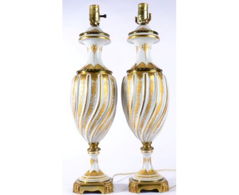 A Pair of Gilt Metal Mounted Sèvres Style Porcelain Lamp Bases, 20th century, of wrythen fluted urn form gilt with bands of f