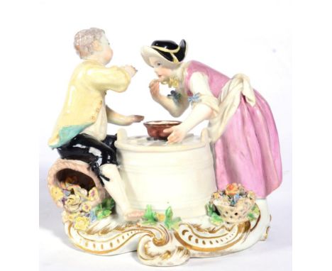 A Chelsea Porcelain Figure Group of a Boy and Girl, circa 1755, she standing, he sitting on a basket of flowers, each eating 