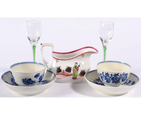 A Pair of Worcester Porcelain Tea Bowls and Saucers, circa 1775, painted in underglaze blue with the three flowers pattern; A