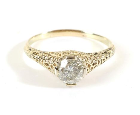 A Solitaire Diamond Ring, a round brilliant cut diamond in a claw setting, to tapering filigree shoulders, estimated diamond 