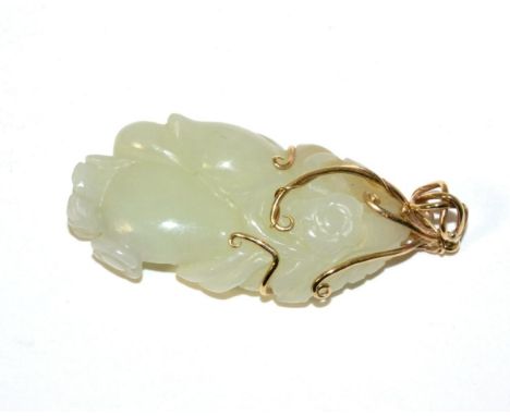 A Chinese Jade Carving, naturalistically modelled with fruit and flowers, 5.5cm high, mounted as a pendantVery minor surface 