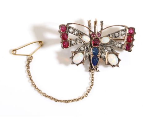 A Gem Set Butterfly Brooch, with ruby, opal and rose cut diamond set wings and a ruby and sapphire set body, measures 3cm by 