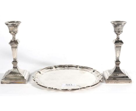 A Pair of Silver Candlesticks, William Hutton, Sheffield 1913, in the neo classical taste, filled; and A Circular Silver Tray