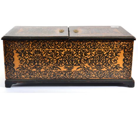 A Pokerwork Tea Caddy, mid 19th century, with two hinged covers over an arrangement of compartments, the whole with foliate a