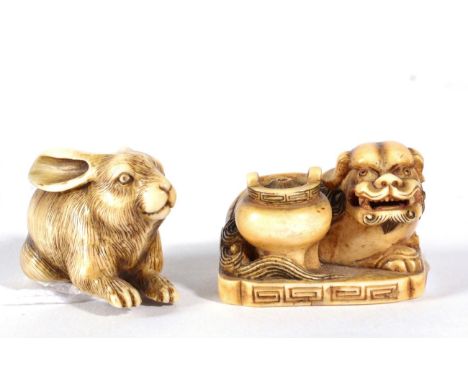 A Japanese Ivory Netsuke, Meiji period, carved as a crouching rabbit, signed, 4cm long; and Another, as a temple dog beside a