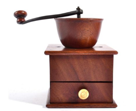 A Treen Coffee Grinder, early 19th century, the steel arm with turned wooden handle, the base drawer with turned ivory handle