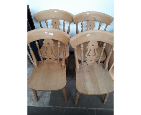 A SET OF FOUR LIGHT WOOD KITCHEN CHAIRS