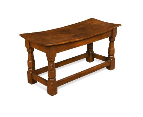 Robert 'Mouseman' Thompson, an oak long stool,  the dished adzed top on octagonal supports united by stretchers, carved mouse