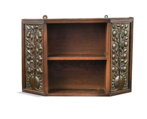 An Arts &amp; Crafts oak hanging shelf,  the two open shelves flanked by embossed copper panels 34.5 x 51 x 11cmIn generally 