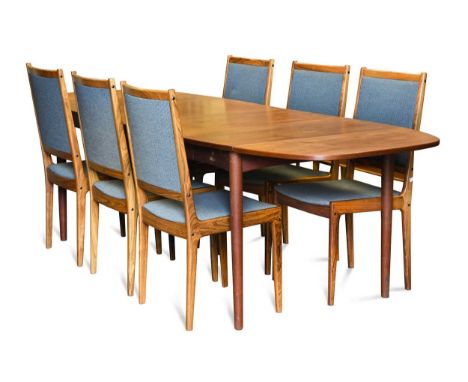 zzz A mid-century Danish teak extending dining table and six chairs, the table extending to a rounded rectangular form raised