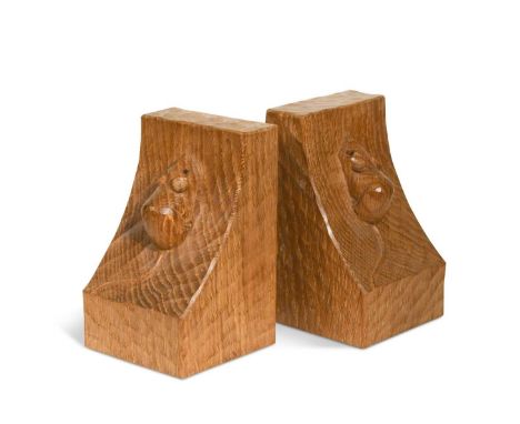 Robert 'Mouseman' Thompson (1876-1955), a pair of oak bookends, of curved adzed form and each relief carved with a single mou