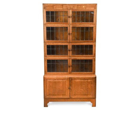 An Art Deco sectional oak bookcase by Minty of Oxford,  with four glazed sections over a cupboard base174 x 89 x 37cmOne hand