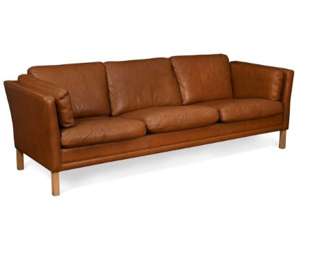 A Danish brown leather three-seat sofa,  raised on square section beech legs66 x 217 x 77cmGeneral scuffs and marks commensur