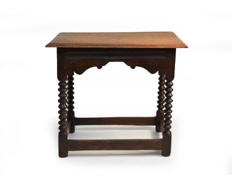 A joined oak occasional table, 18th century and later, the moulded top a later replacement, above a channel moulded frieze wi