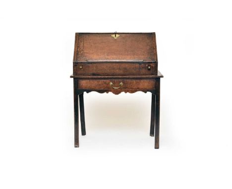 A 19th century oak table bureau, with beaded fall front opening to a fitted interior with pigeon holes and central well with 