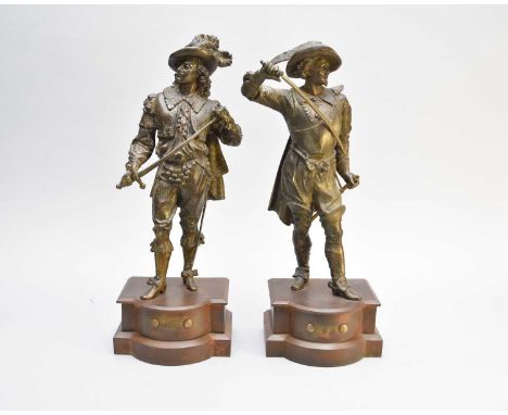 Two bronzed alloy figures of Cavaliers, circa 1900, each modelled standing and holding a sword, set on cast metal pedestal ba