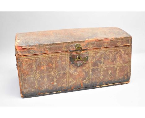 A George III tooled and gilt leather-covered pine dome topped travel trunk, decorated with GR cyphers and crowns within a tre