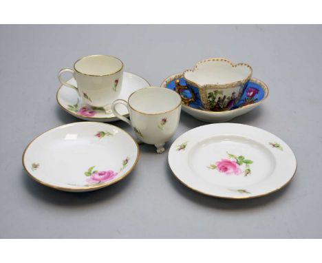 A Dresden quatrefoil cabinet cup and saucer decorated with Antoine Watteau-esque panels interspersed by blue panels with flow