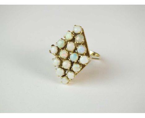 An opal dress ring, designed as a diamond shaped cluster comprised of sixteen round cabochon opals claw set in yellow metal t