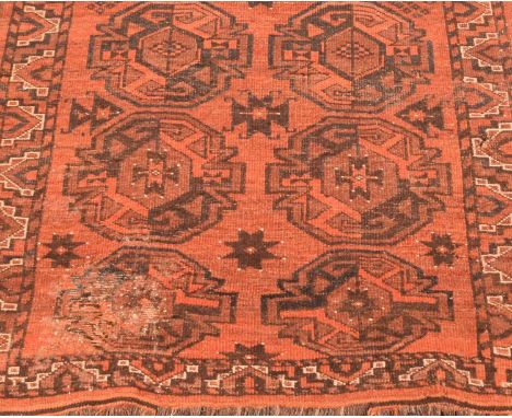 Two Afgham Bokara pattern rugs, each with multiple guls on a red field within geometric borders, 185cm x 106cm and 175cm x 92