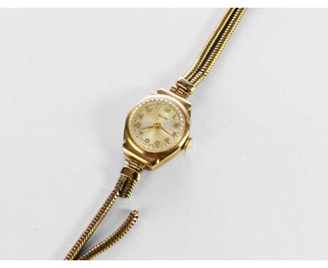 A 9ct gold Rotary bracelet wristwatch, the engine turned cream dial with Arabic numerals, with attached two strand stylised c