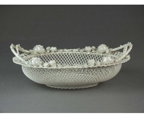 A Belleek oval basket, First Period (1865-1899)the three-strand basket of twin-handled form, decorated with roses and other f