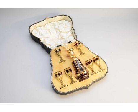 A Venetian glass liqueur setcirca 1930s-50sthe clear glass with ruby overlay panels and gilded decoration, the set comprising
