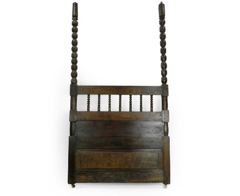 An 18th/19th century oak four-poster bed, with 'knob' turned uprights and fielded panelled bases, lacking cornice, restoratio