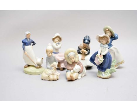 Three Lladro figures, comprising 'Eskimo Playing', model 1195; 'Pretty Pickings', model 5222 (boxed) and a boy with a lamb, t