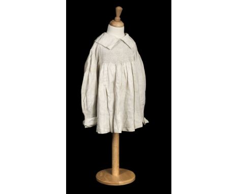 * Infant's clothing. An early child's smock, English, circa 1850, white linen smock, with hand-stitched smocking to yoke fron